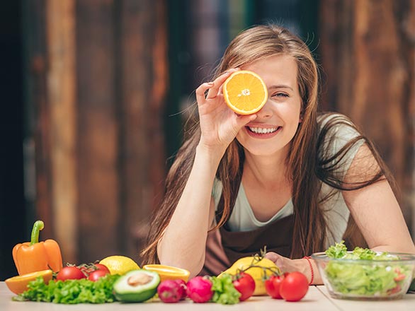 girl sitting in front of a table with food