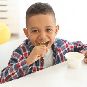 A kid eating a bowl of icecream.