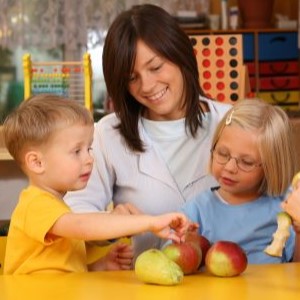 A teacher with children eating apples.