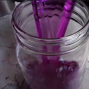 pH test liquid being poured in a jar