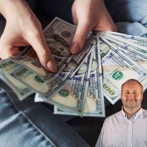 Hands holding money with Mike Bindrup