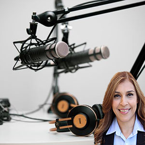 Microphones and headphones on a desk with Reyna Mendez