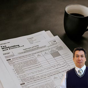 Several tax forms and cup of coffee with Juan Salas