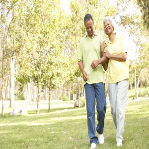 Older adult couple walking in park.