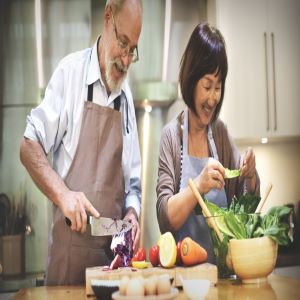 An older adult couple cooking a healthy meal.