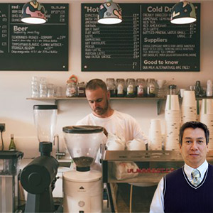 Man standing behind a coffee counter with Juan Salas