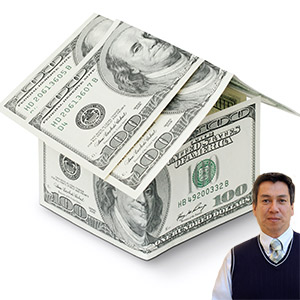 Several $100 bills stacked to look like a house with Juan Salas