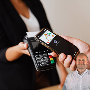 Lady holding a POS terminal and someone using a phone to pay with Mike Bindrup