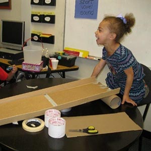 girl playing with cardboard