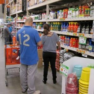 People shopping for pesticide products in a hardware store.