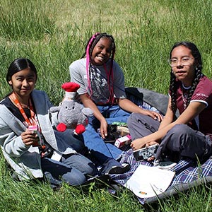 youth sitting on blanket