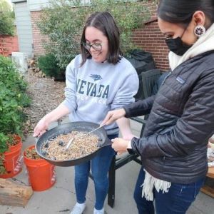 students roasting pine nuts