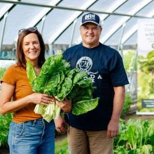 DFI staff standing in a hoop house