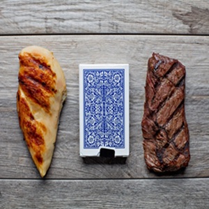 serving size depiction with a chicken breast and piece of steak next to a deck of playing cards