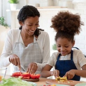 Woman and child preparing food together.