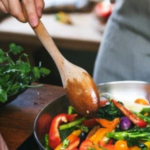Person cooking various vegetables.