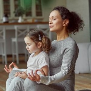 Mother and daughter practicing yoga.