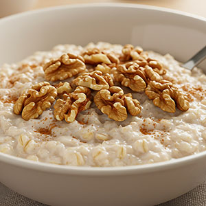 oatmeal with walnuts in white bowl