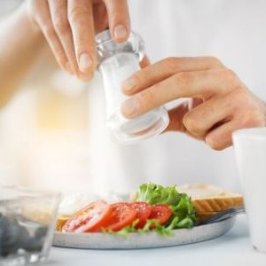 Adding salt to a meal.