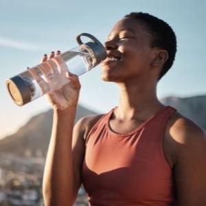 A person drinking from a water bottle.