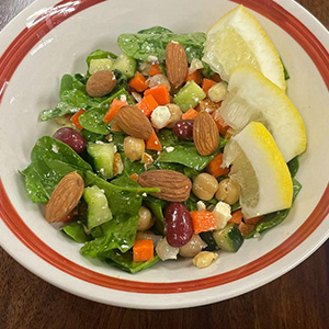 salad in a bowl with vegetables and for on the side.