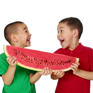 two boys holding a large watermelon wedge