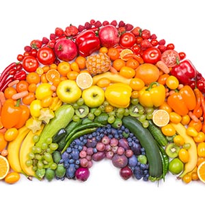 fruits and vegetables arranged in a rainbow