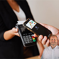 Women holding a POS machine and person swiping phone over it with Mike Bindrup