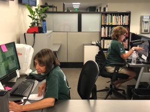 Two Master Gardener volunteers working the help desk answering horticulture questions