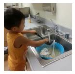 Kid washing dishes