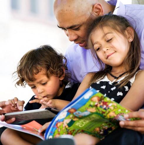 kid and parent reading together