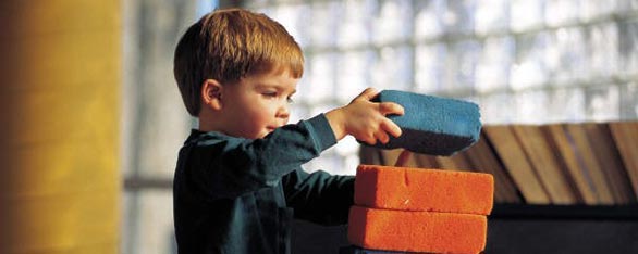kid building with blocks