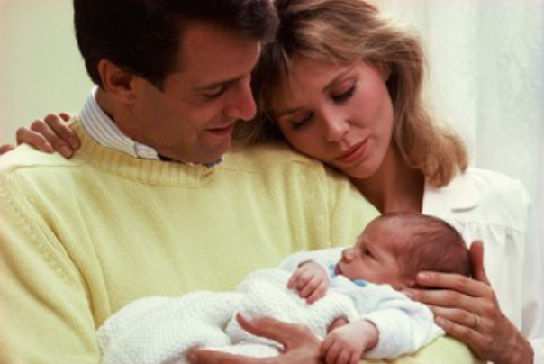 Parents holding baby