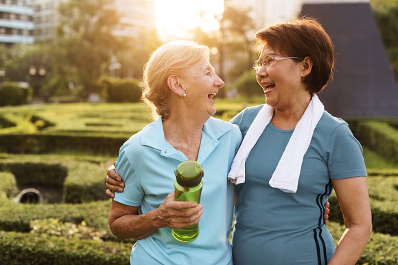 Two women smiling while being active. 