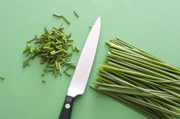 Knife with chopped chives. 