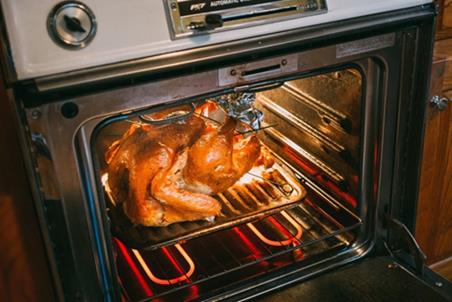 A turkey in a oven.