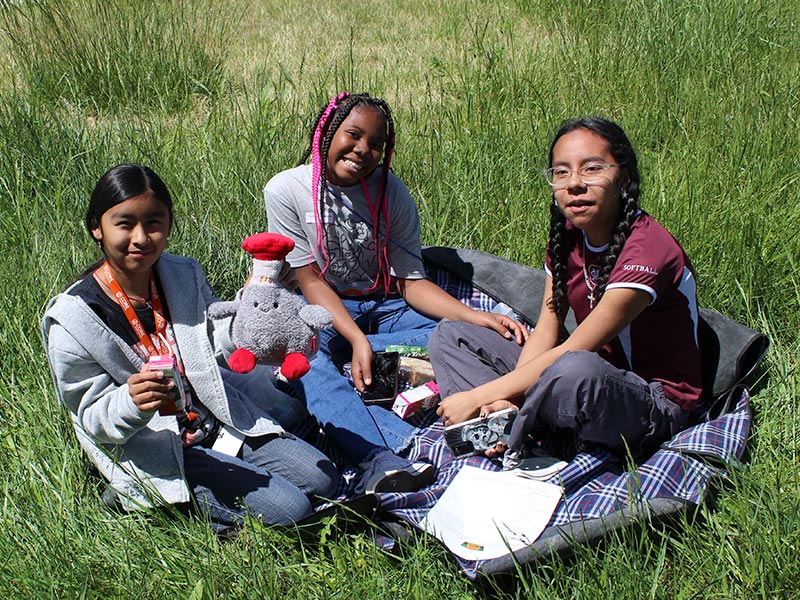 youth doing craft in the front yard