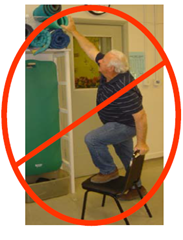 Man standing on chair reaching with a red x through the picture