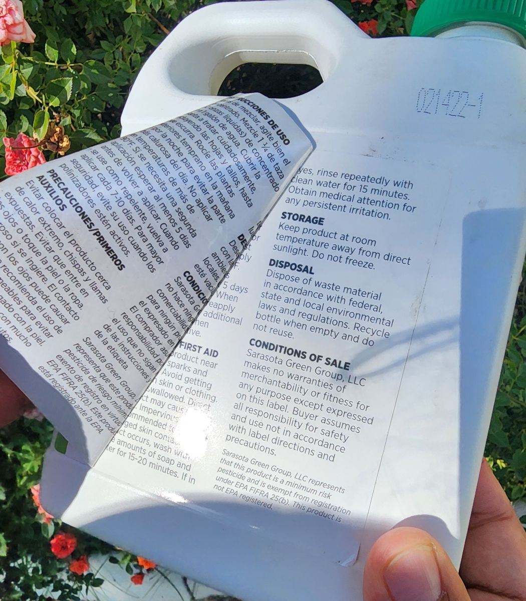 A pesticide label peeled back to show how some of the labels open up with more information inside.