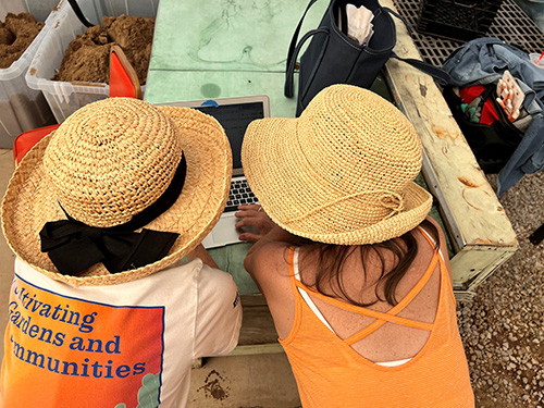 two people wearing sun hats.