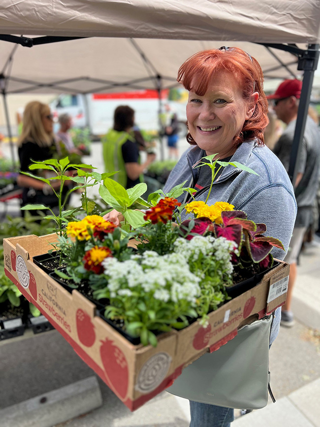 A person holding a box of flowers.
