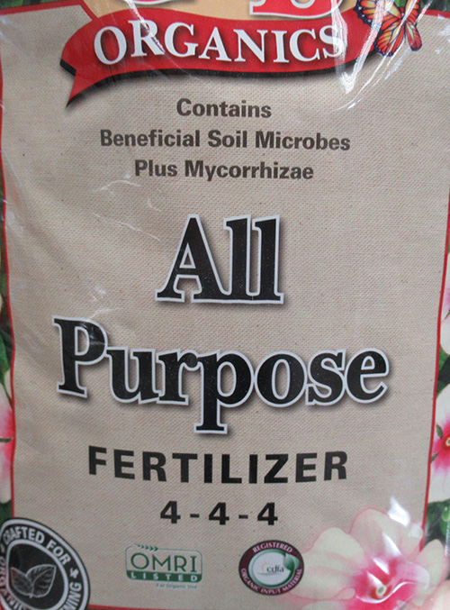 front of a bag of soil that reads: all purpose fertilizer 4-4-4