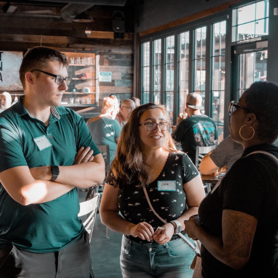 Individuals talking at Food Business Center Mixer