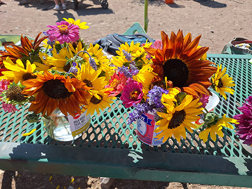 red and yellow sunflower bouquets on a greed table.