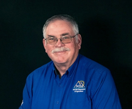 Photo of a man in a blue shirt.