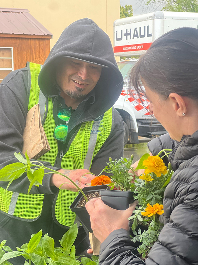 Two people exchanging plants.