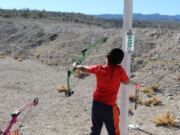 Youth shooting archery