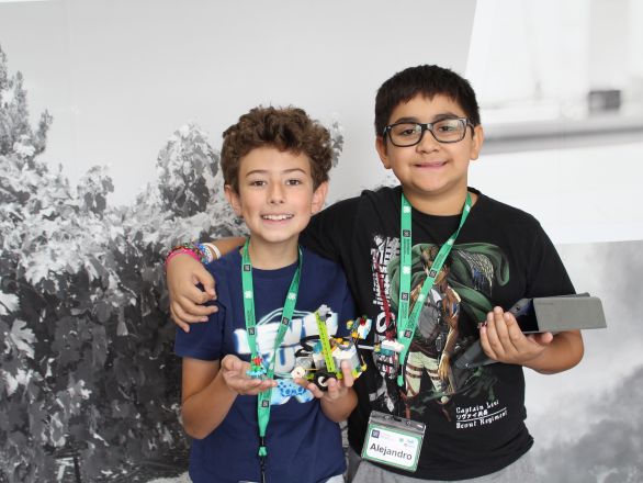 Two students holding their robots