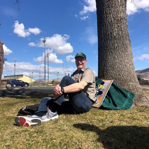 Master Gardener Rod sitting under tree during a tree walk