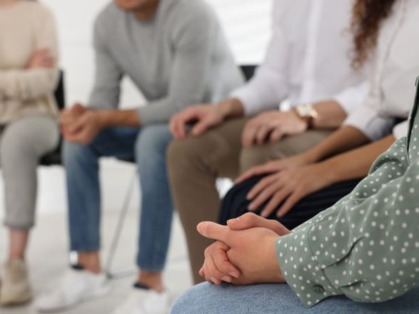 A group of people in circle listening to one another.